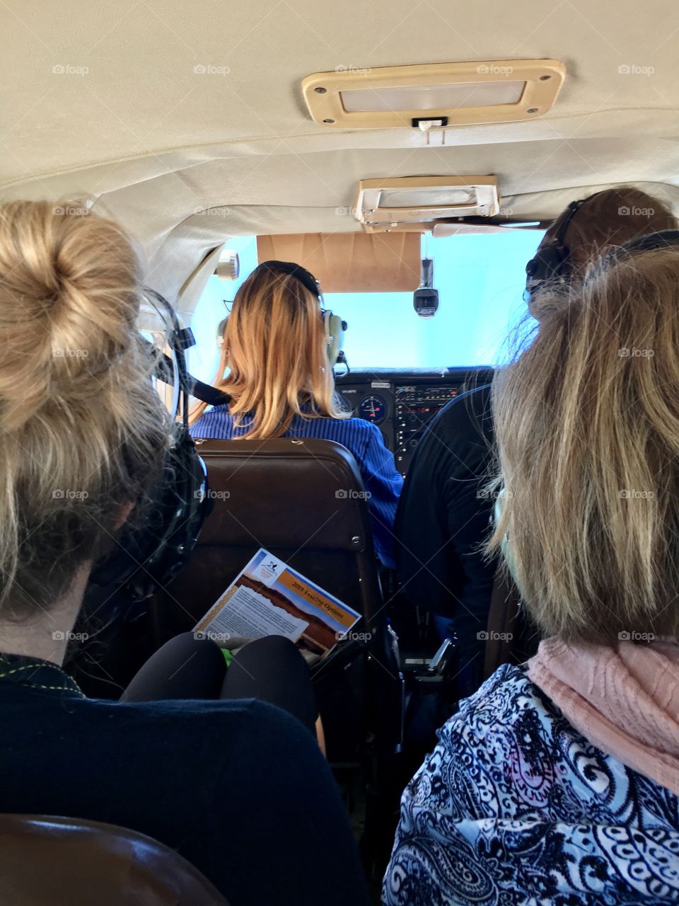 Female pilot and passengers in light plane