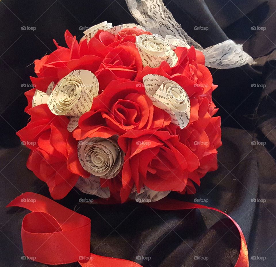 red roses and paper book flowers