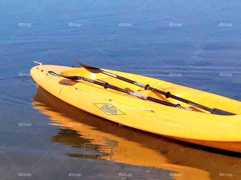 Color vs Black and White: a kayak was waiting for your rowing at seaside.