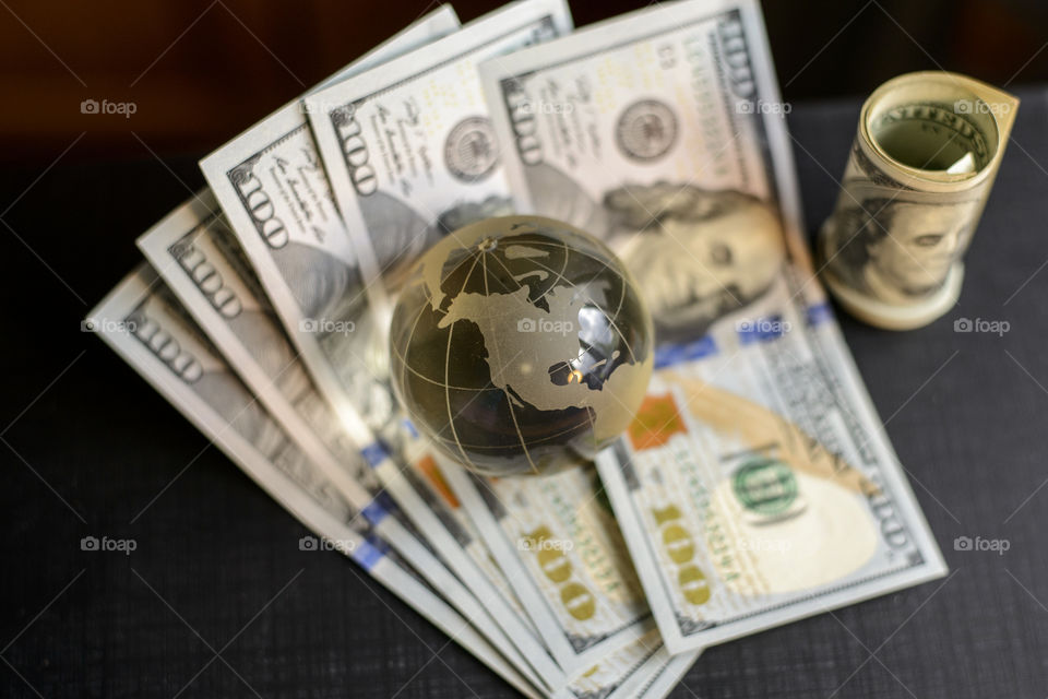 transparent globe on dollars