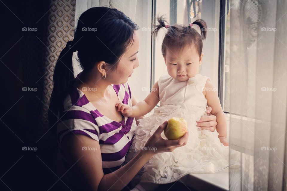 Baby, apple and mom