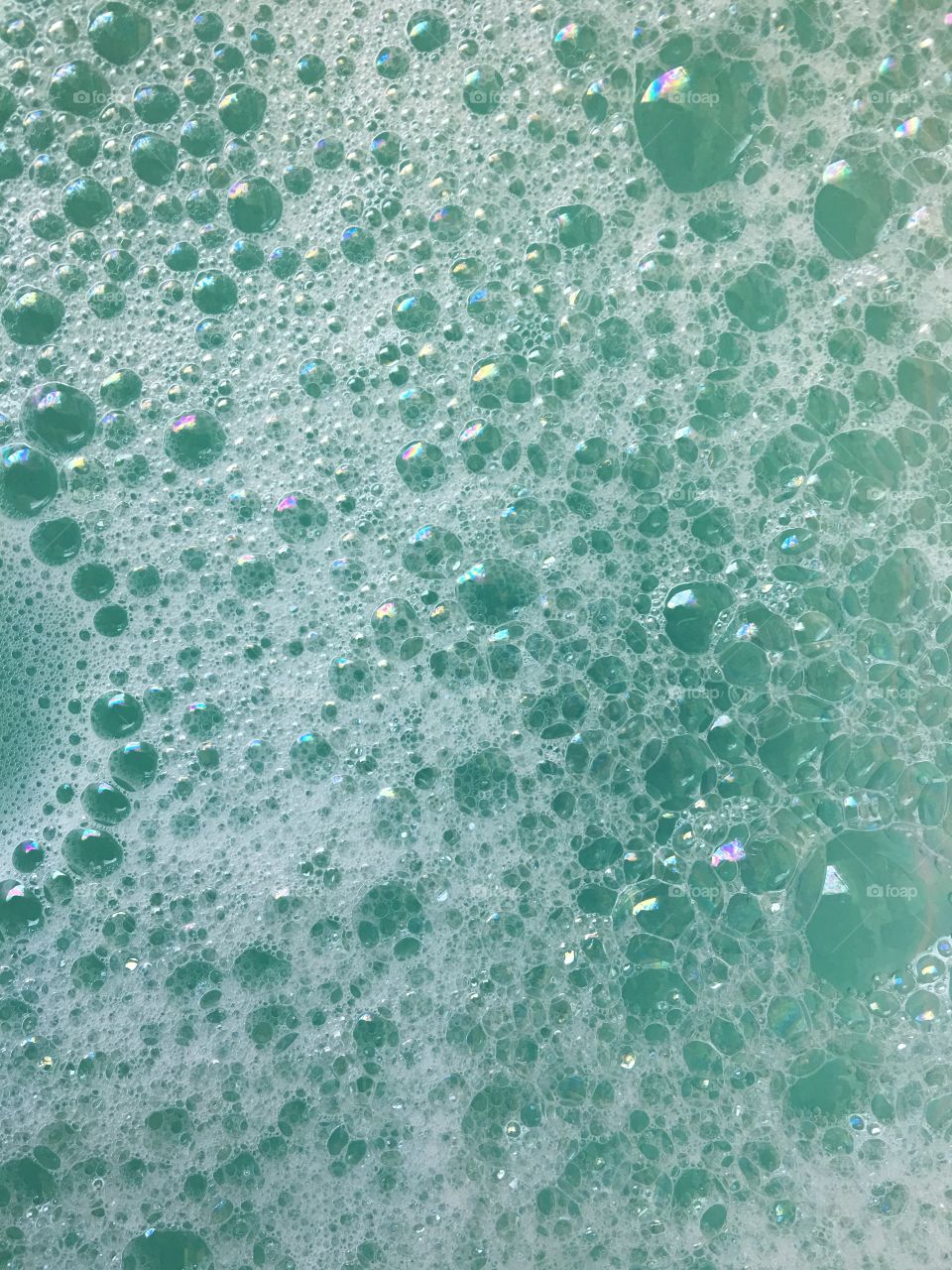 Turquoise background with colorful bubbles 