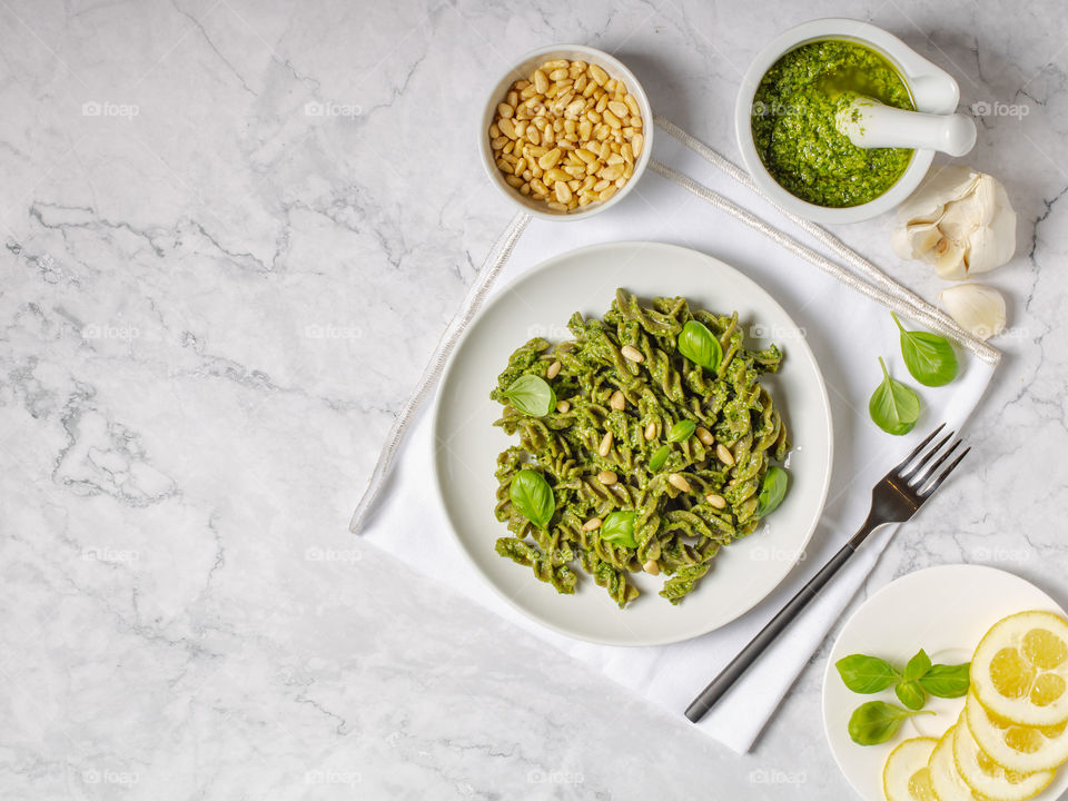 Green fussily with basil pesto. Top view with copy space