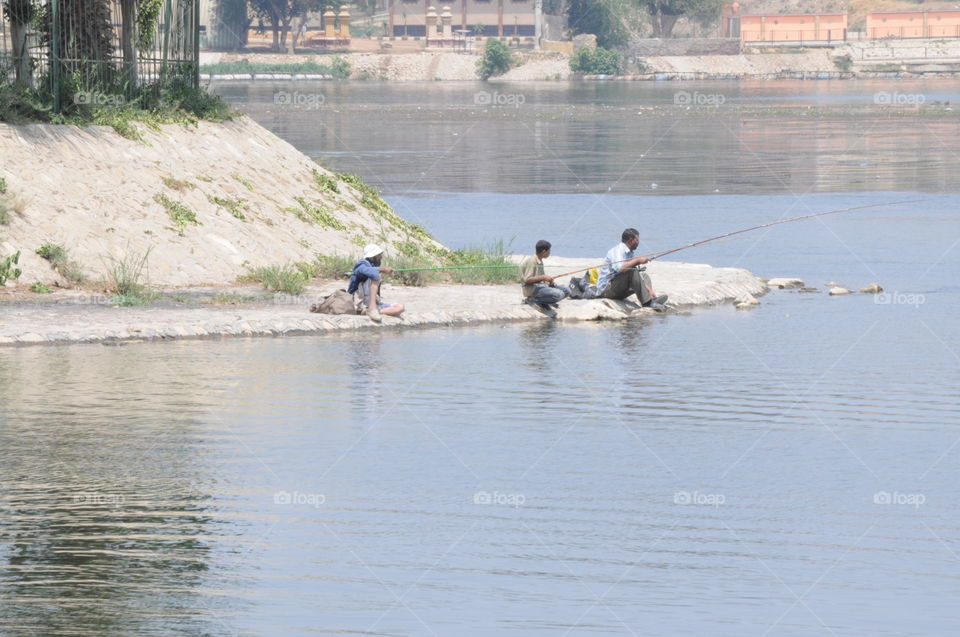 men fishing on the Nile River