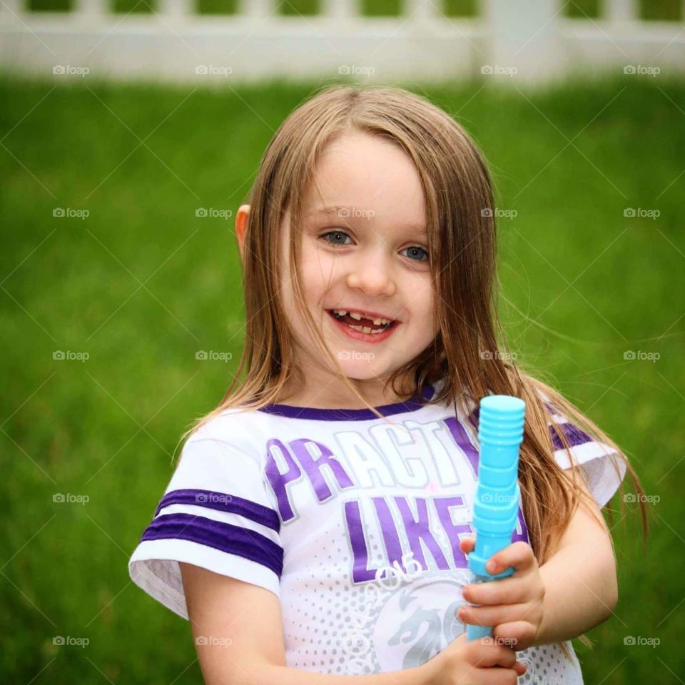 happy with blowing bubbles in summer