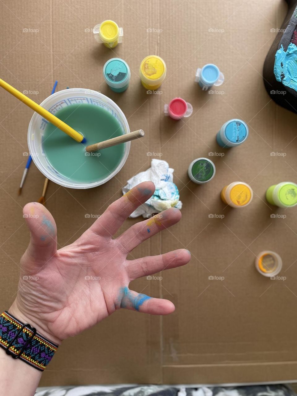 Woman’s hand with paint on it, painting with toddlers, making a mess while crafting, crafting with paint, making a present with toddlers