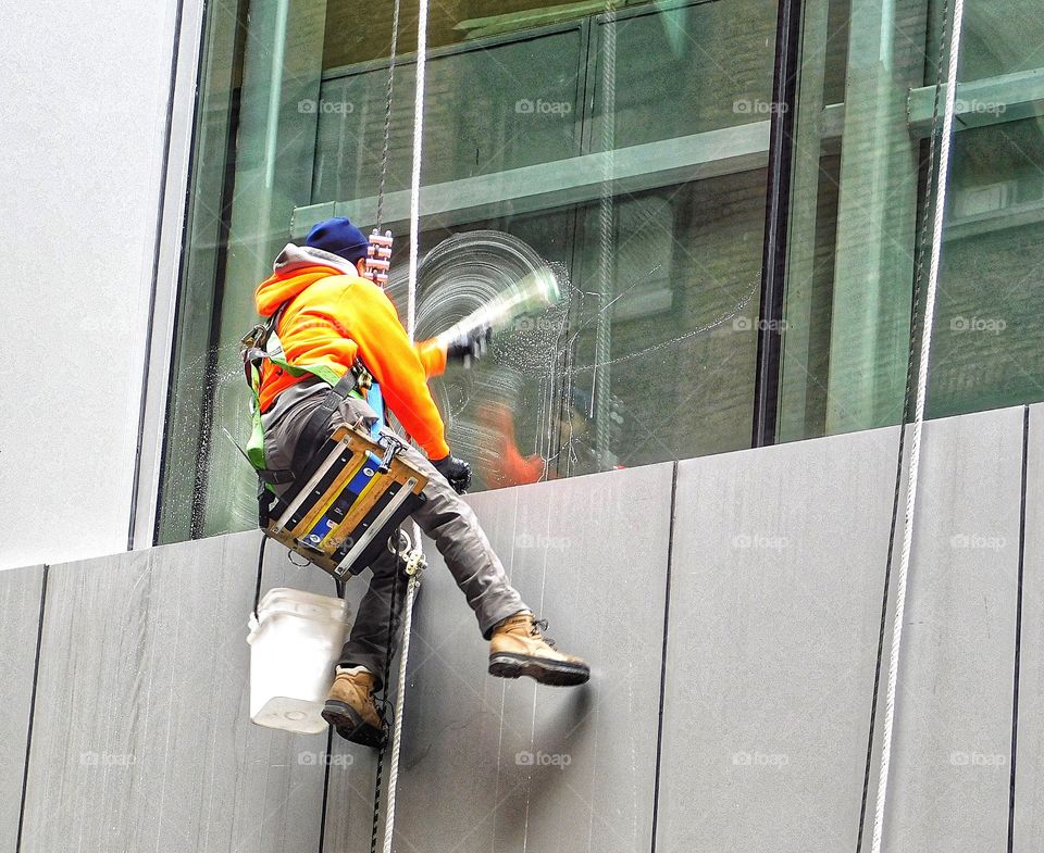 Cute guy cleaning windows in Midtown Manhattan 