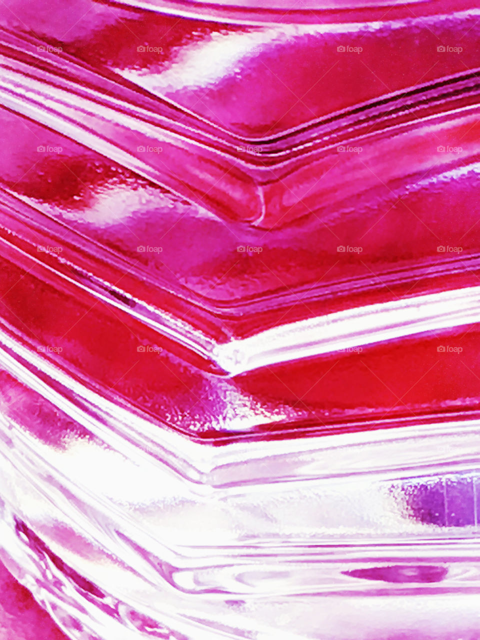 Magnified water bottle with hot pink reflections