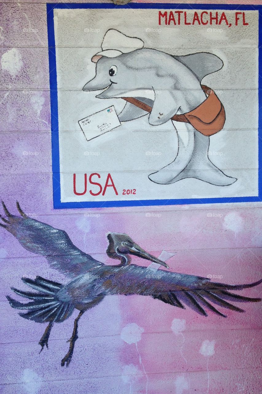Dolphin mail carrier and pelican stork mural on post office wall