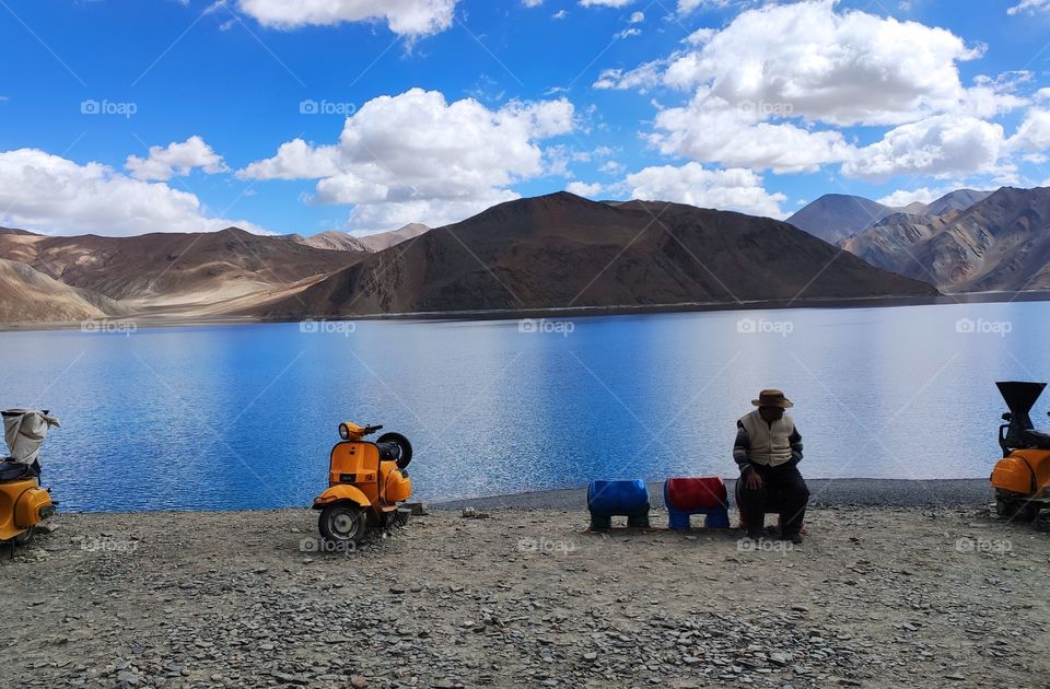 SKY SEA SAND decorated with clouds, shadow, mountains, pebbles,humans and their creation. Capture of Ladakh's Pangong lake crystal clear blue water surronded by white nd brown giant mountains roof of dreamy sky. So scenic.