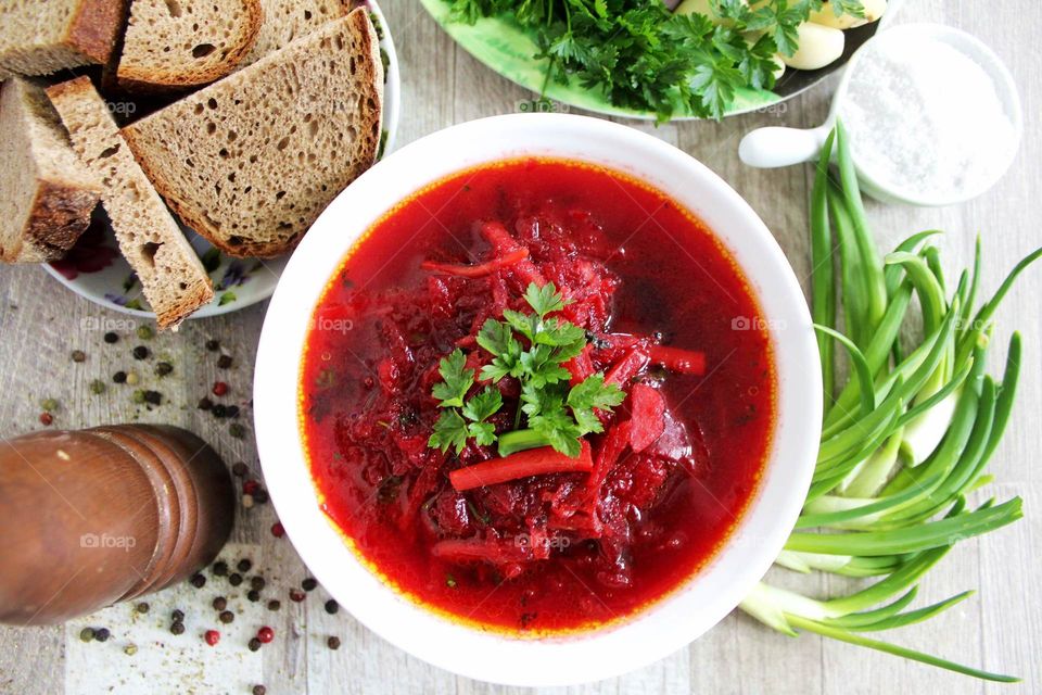 Beetroot soup (Ukrainian borsch) with bread, lard and greens.