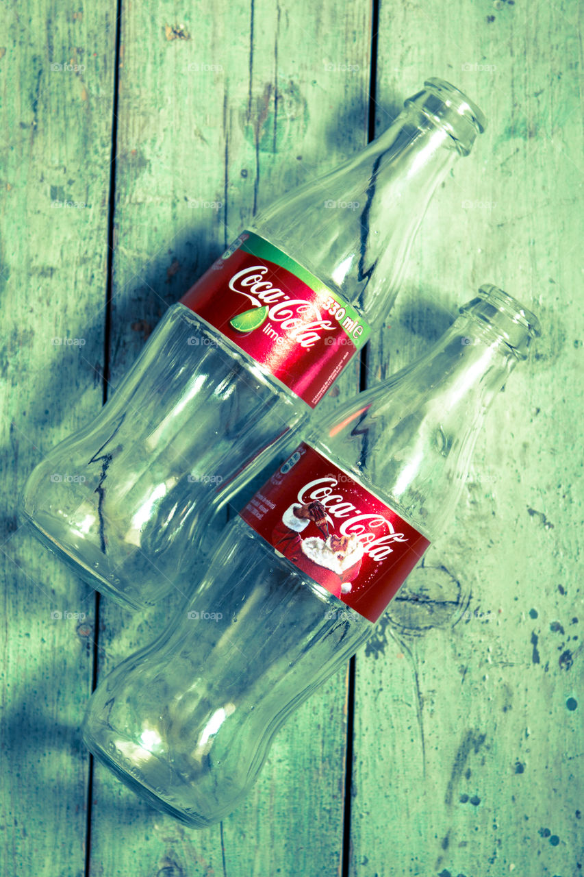 bottles of Coca cola on a wooden table