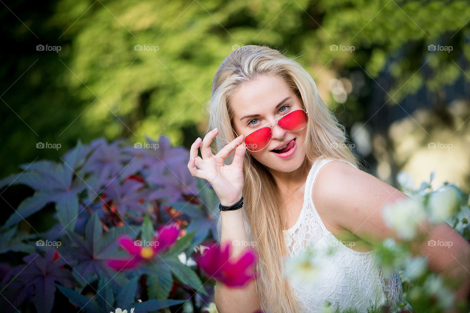 Portrait of young woman with red color sunglasses