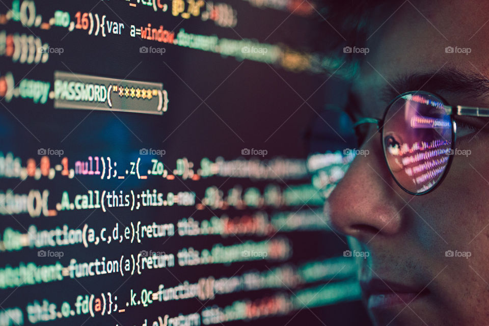 Hacker using computer, smartphone and coding to steal password and private data. Computer screen displaying program code, website development, application building, password and private data