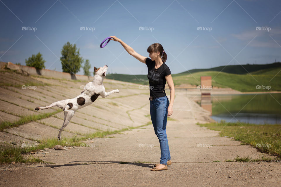 Woman playing with dog in park