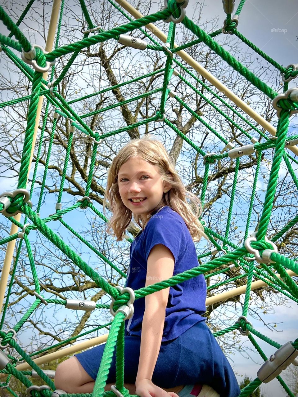 Having fun playing at a playground on a pretty spring day 