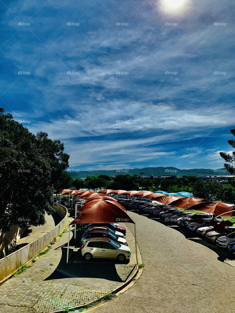 Shaded parkings for staff members in front of the hospital on a hot sunny day. 