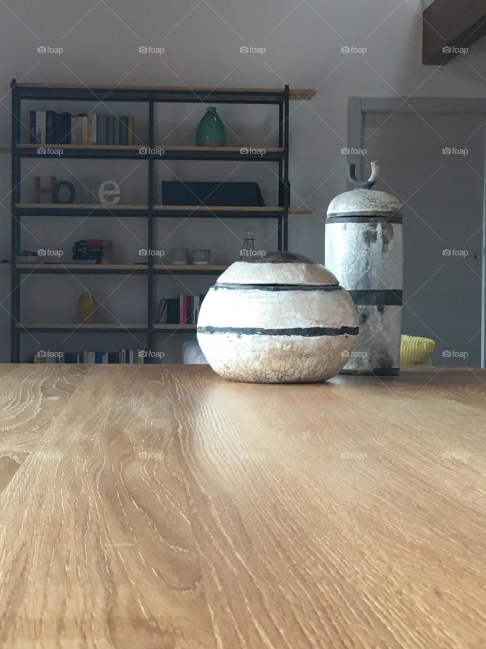 Two vases made of raku ceramic. An ancient Japanese technique that involves the use of refractory clay fired at 1000 °C for three times and then undergoes the reduction of oxygen to obtain the cracklé effect.