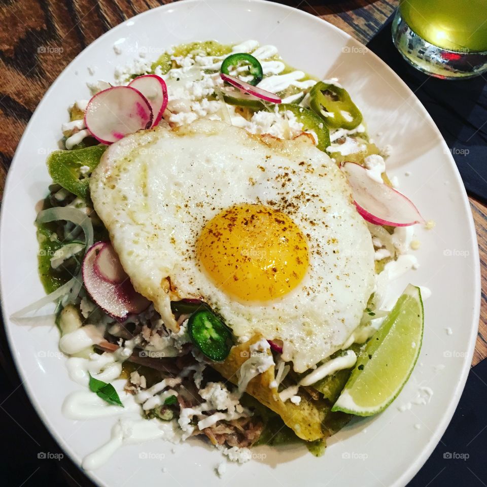 Traditional Mexican chilaquiles topped with a fried egg. 