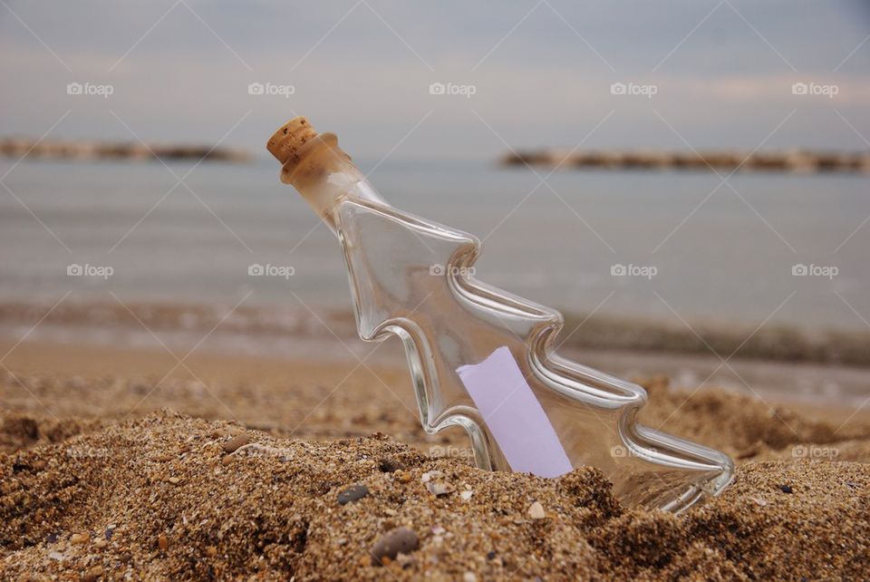 Hope message in the bottle on the sand