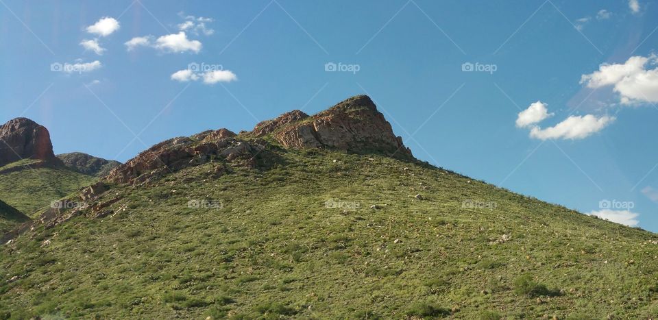 Green Desert Mountain Against Blue Sky and  Few Clouds, El Paso, Southwest Texas