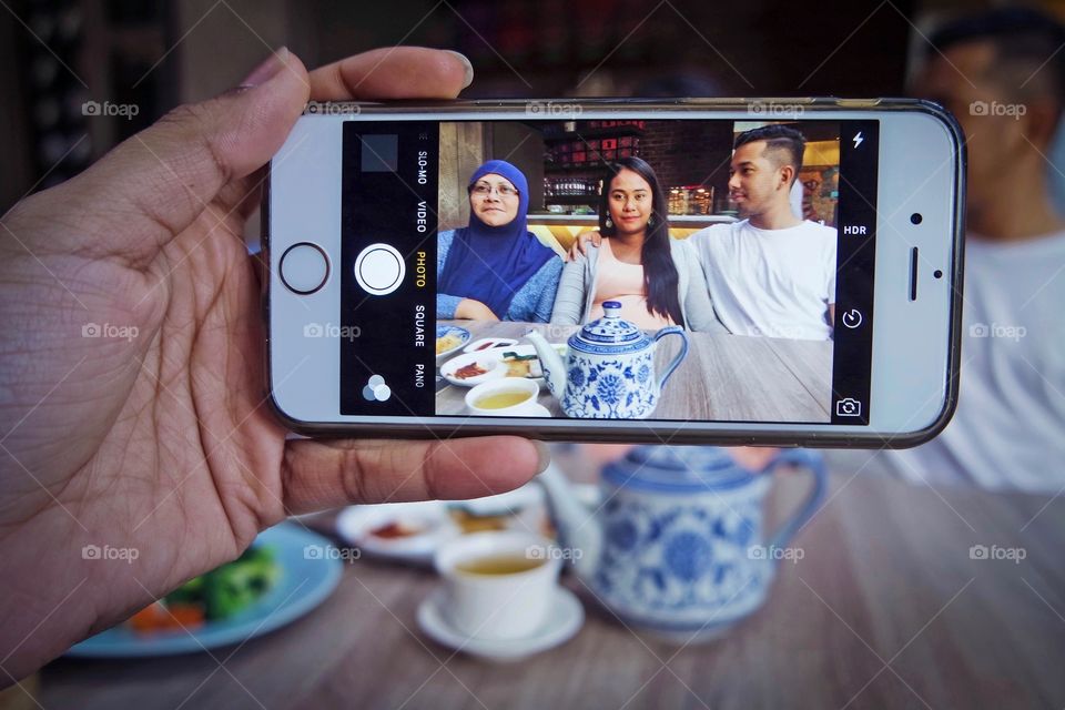 Hand's taking photograph in mobile phone