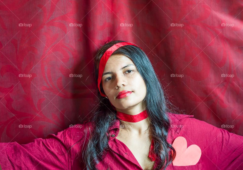Woman in magenta color shirt with magenta color background.