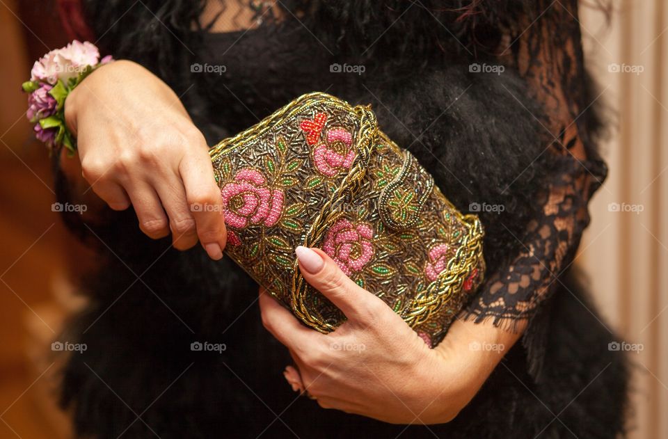 Mid section of woman holding purse