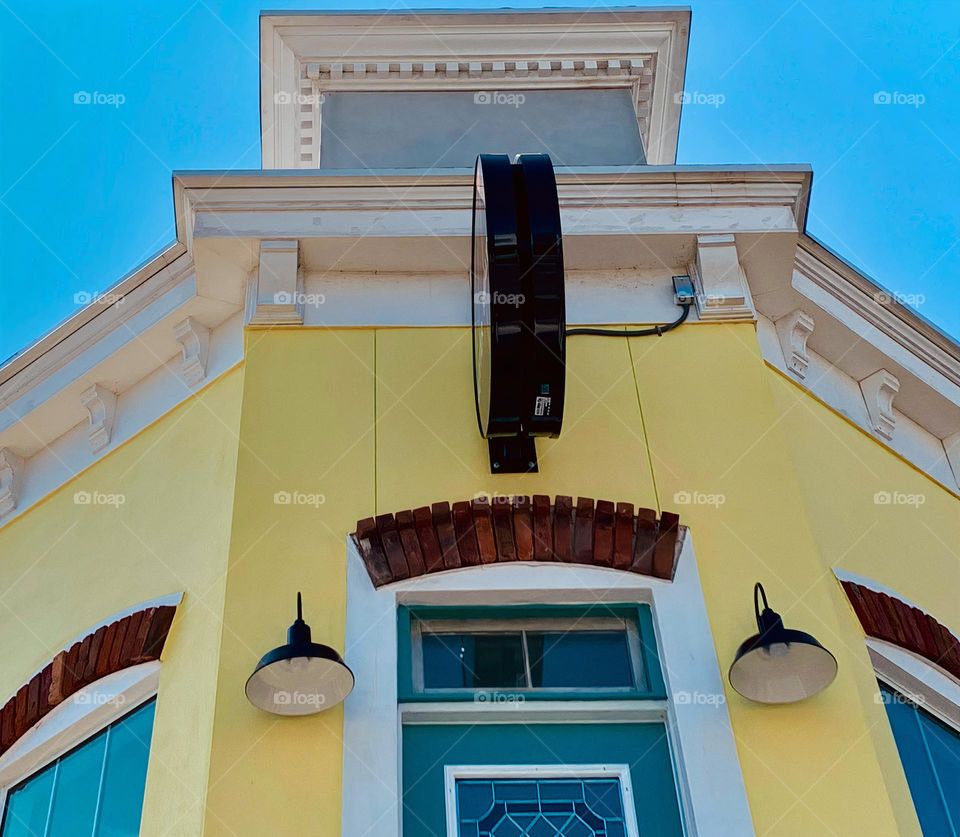 European style architectural top of commercial and historical yellow charming building from balcony.