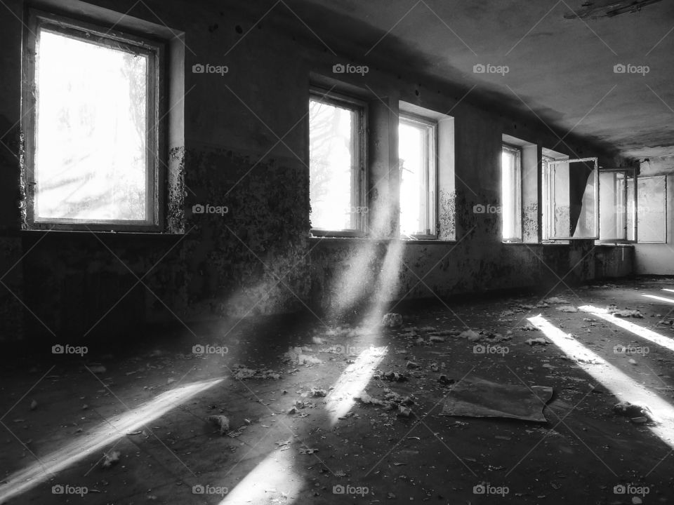 Beautiful light coming through the windows in an abandoned factory room