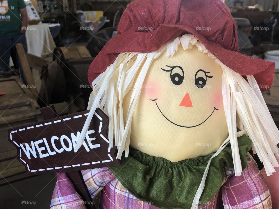 A smiling welcome scarecrow