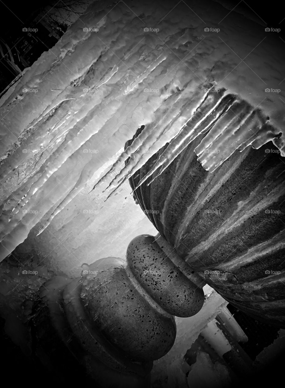 Frozen fountain in the winter, black and white 