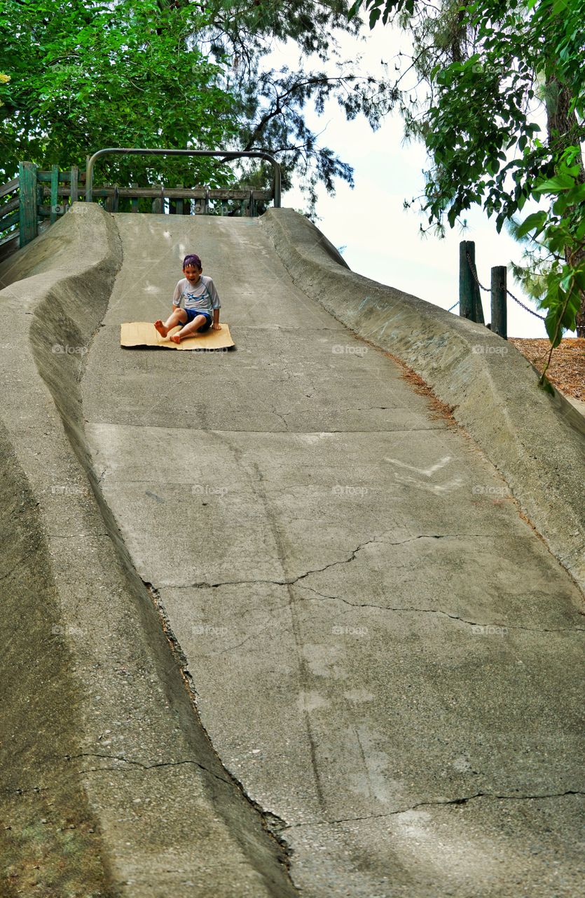 Boy Riding Down A Giant Slide