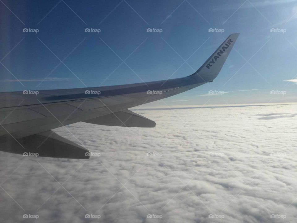wing aircraft flying in the cloudy sky