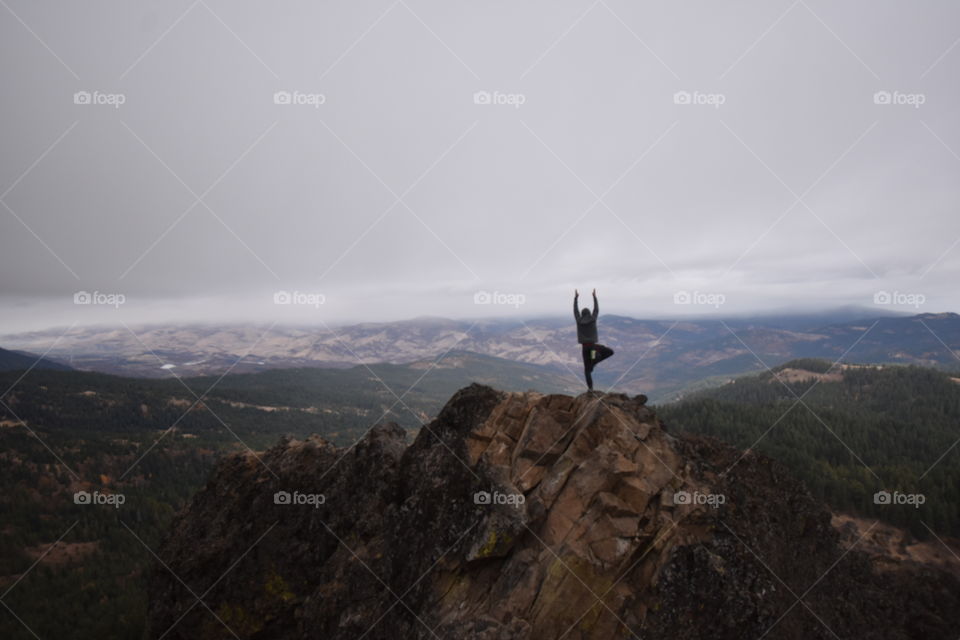 Doing yoga after rock climbing to the summit of Pilot Rock, looking over the quaint, small town of Ashland, Oregon. 