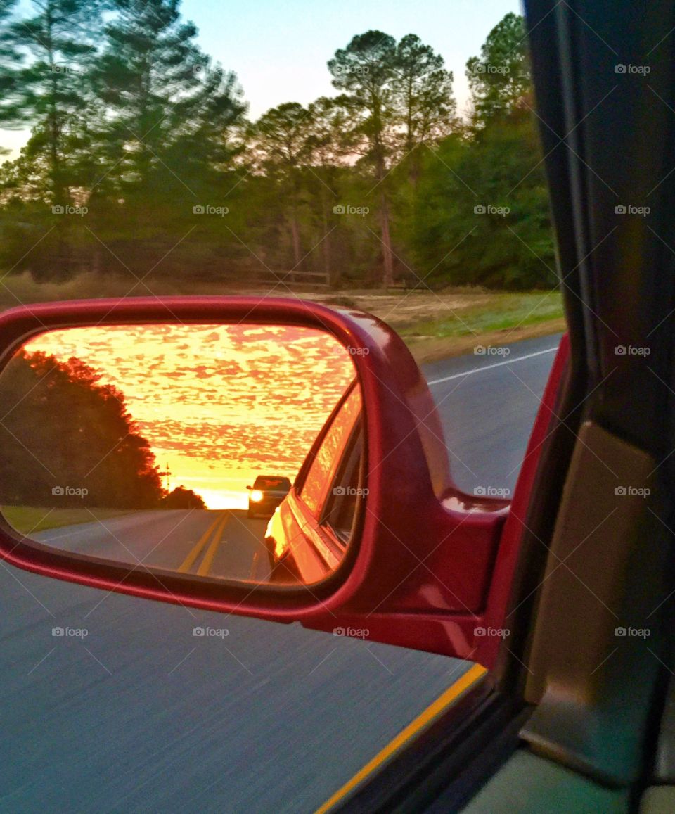 Looking at the sunrise behind me through the side mirror