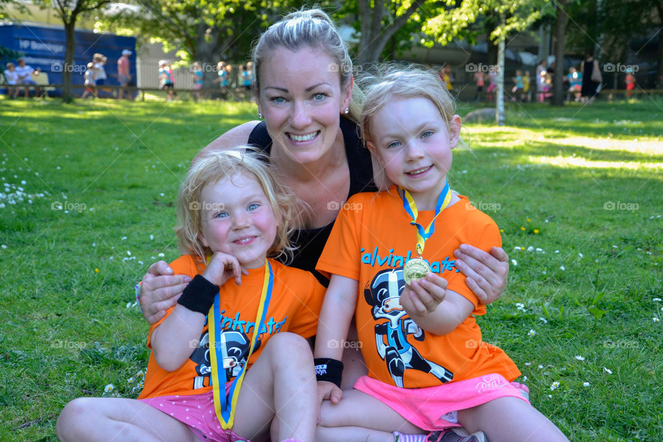 Mother with her two doughters after running a race in Stadsparken in Lund Sweden.