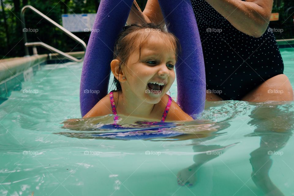 Mother and daughter in swimming pool