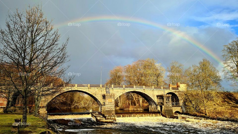 Rainbow over an old bridge