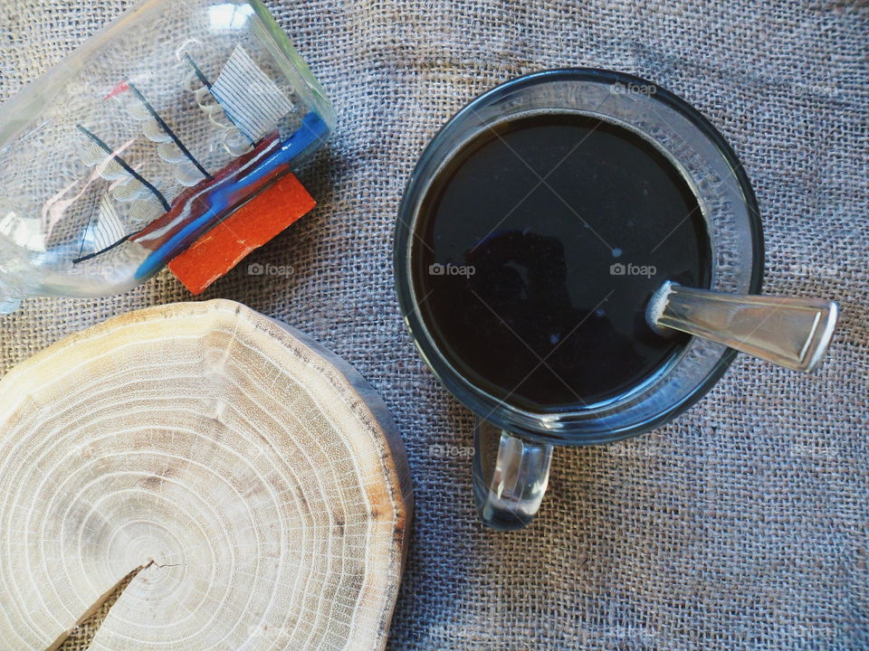 Cutting tree plaque, boat and a cup of black coffee