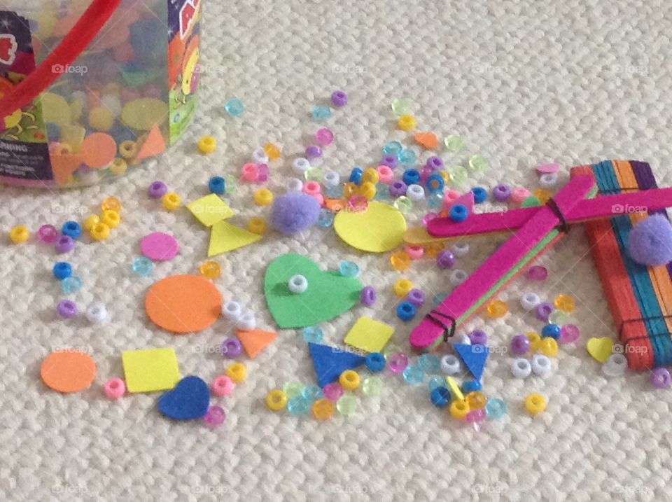 Colorful beads, popcicle sticks and different shape stickers for arts and crafts supplies. 