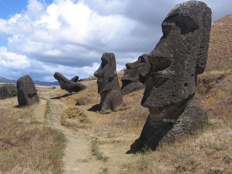 Easter Island. These giant stone heads, or "moai", are scattered along the side of a dormant volcano that served as the quarry for the stone used to carve these mysterious icons.