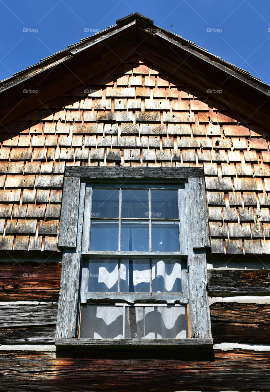 Window and roof of historic log cabin