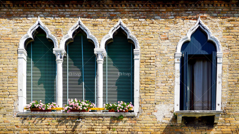 Brick wall with windows and doors in itlay
