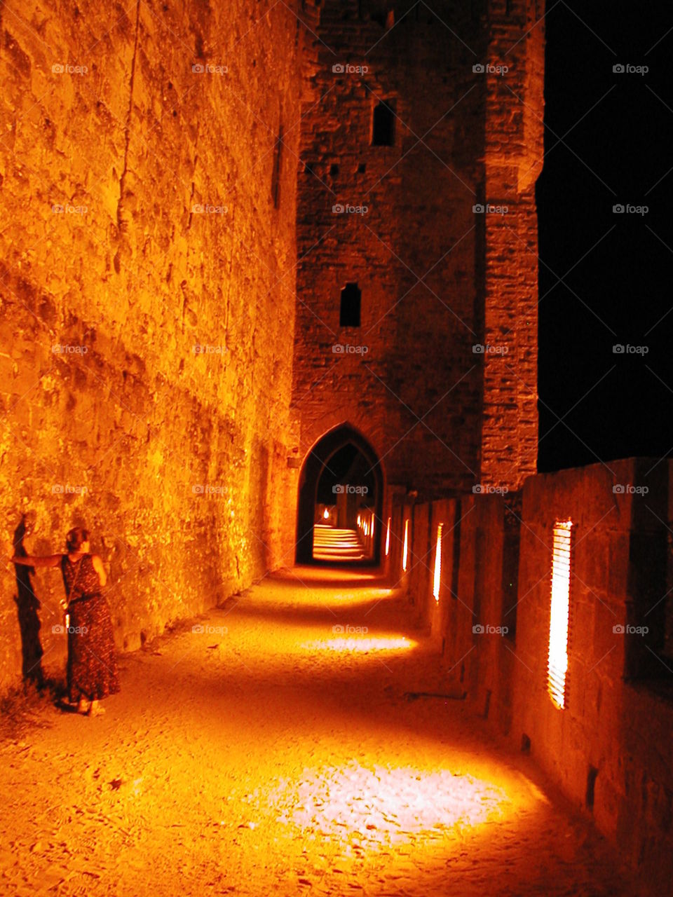 One night in Carcassonne. My sister standing alone next to an anxious while in the medieval city of Carcassonne