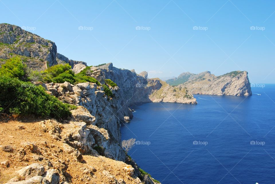 View of blue sea by cliffs