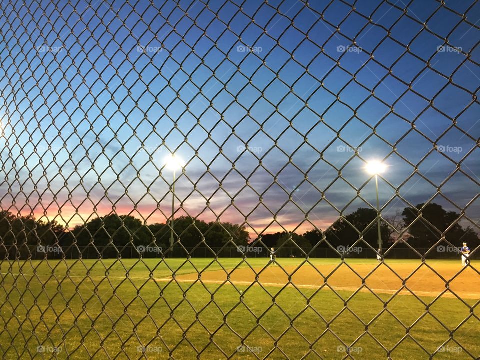 Youth baseball game at evening in Texas.