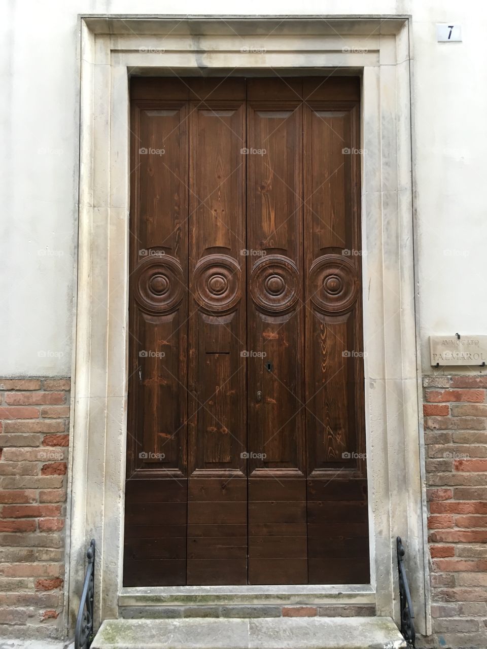 Old wooden renewed door, Offida, Italy