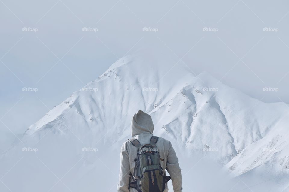 Person looking at the snowy mountains 