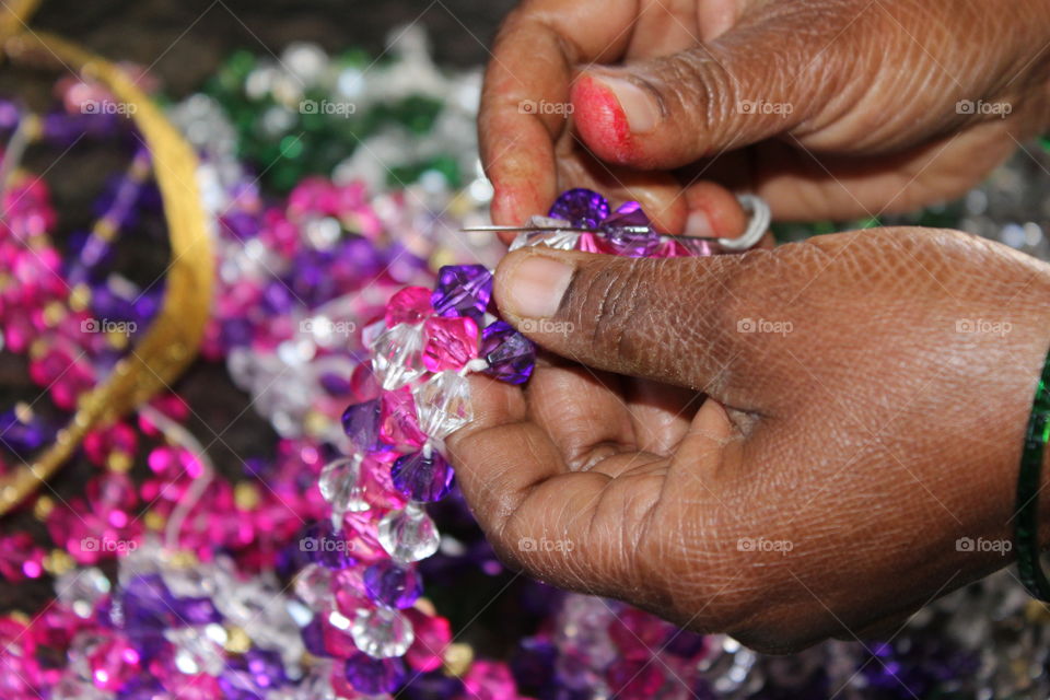 Close-up of a woman preparing bracelet